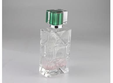 botella de perfume de vidrio transparente